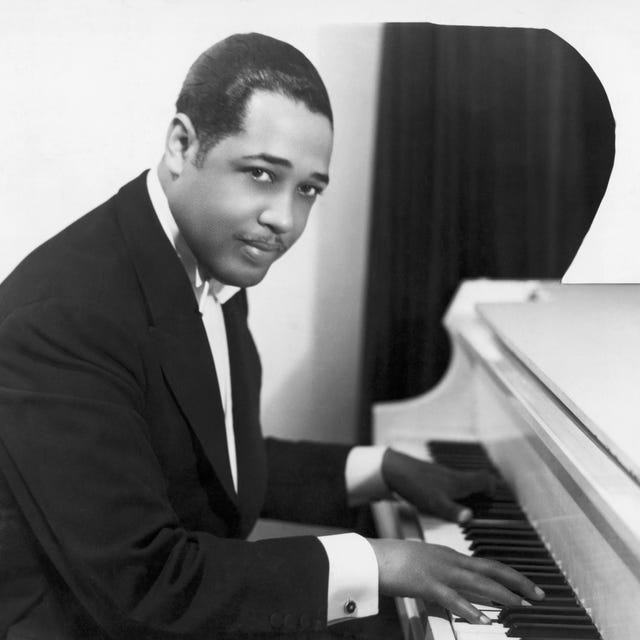 duke ellington seated at the piano