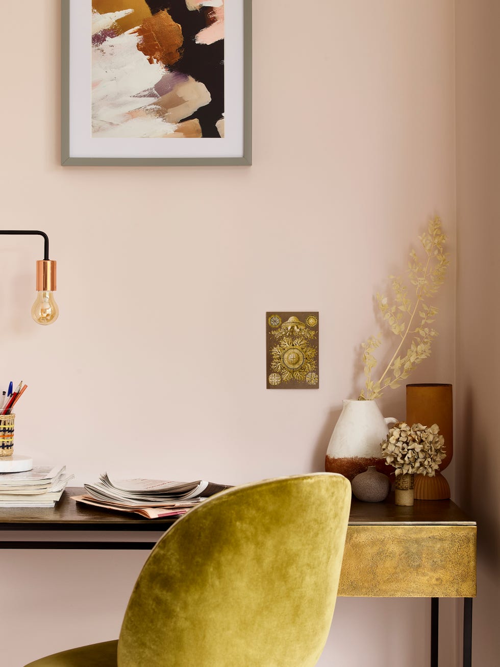 A green chair in front of a painted white wall