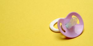 Dummy Pacifier on Yellow Background