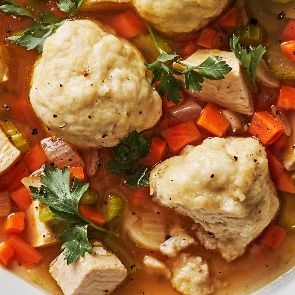 dumplings in a chicken soup with carrots and veggies