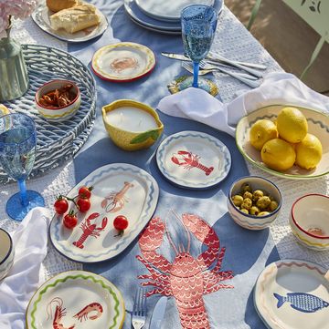 table dressed with dunelm homeware including lobster table runner and crockery decorated with seafood prints