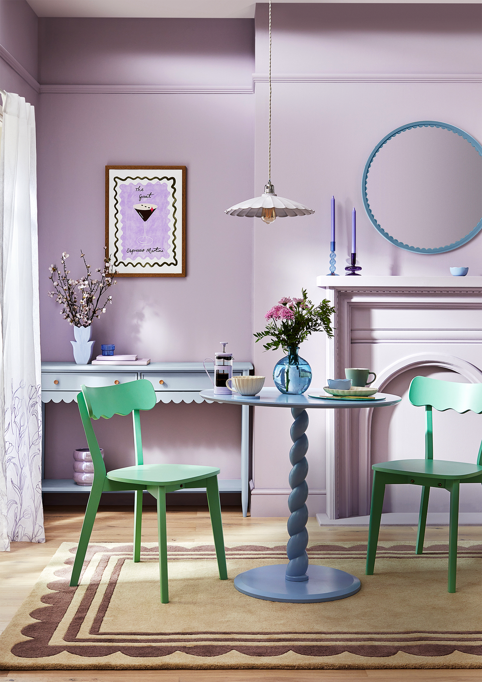 two green chairs in a pale purple room