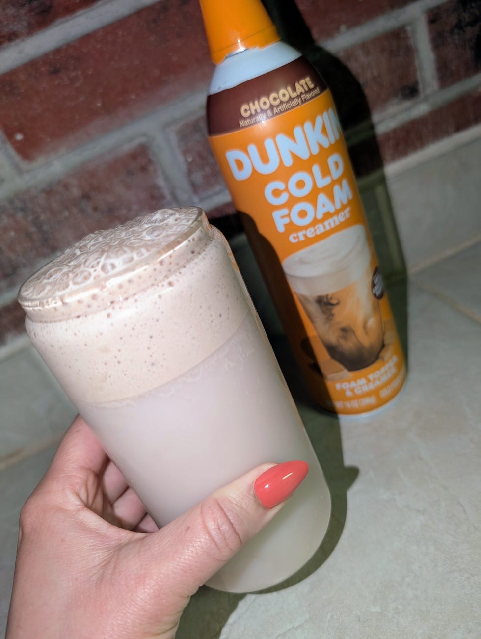 dunkin cold foam creamer and a glass with chocolate foam
