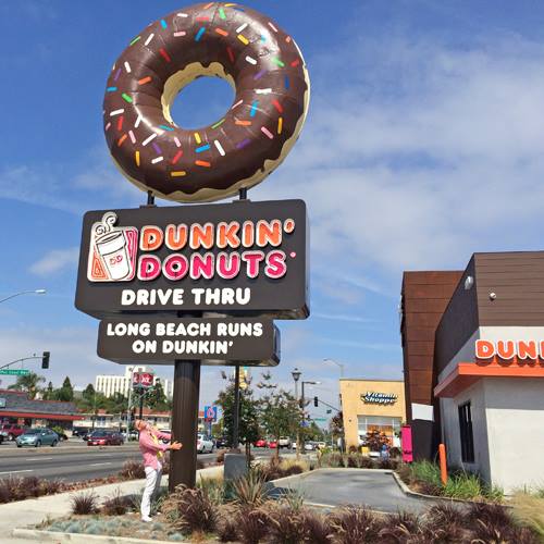 Doughnut, Sky, Bagel, Font, Tire, Real estate, Signage, Baked goods, Building, Advertising, 