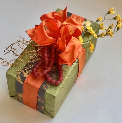 Orange, Present, Ribbon, Cut flowers, Flower, Gift wrapping, Plant, Paper, Floral design, Fashion accessory, 