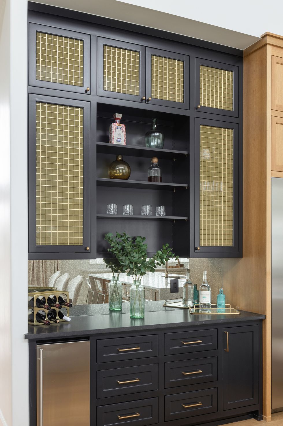 home bar idea, wine rack and fridge and dark blue cabinetry
