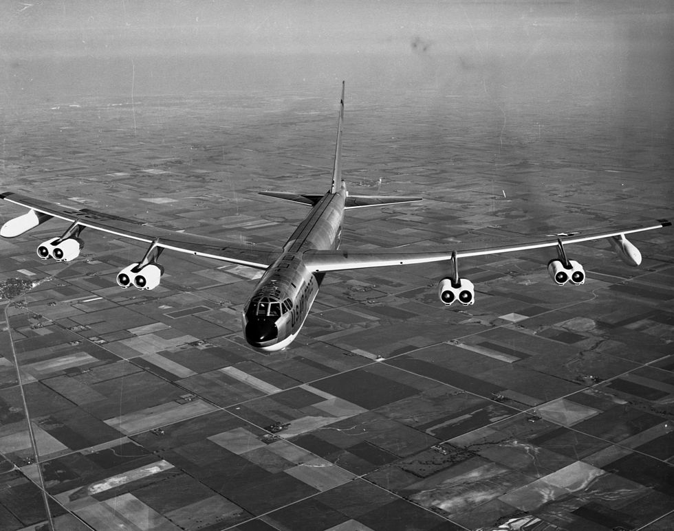 boeing b 52f strategic bomber in flight over farmland