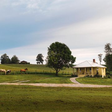a small farmhouse with horses