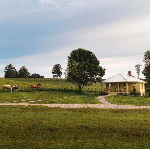 a small farmhouse with horses