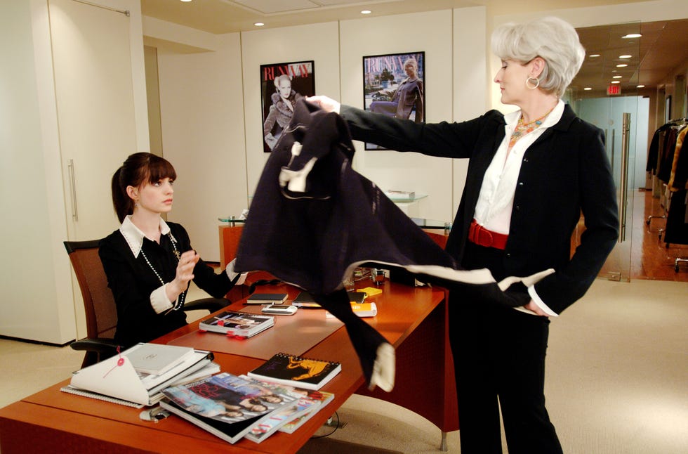 imperious fashion magazine editor miranda priestly meryl streep dumps her coat on the desk of new assistant andy sachs anne hathawayphotographs to be used solely for advertising, promotion, publicity or reviews of this specific motion picture and to remain the property of the studio not for sale or redistribution