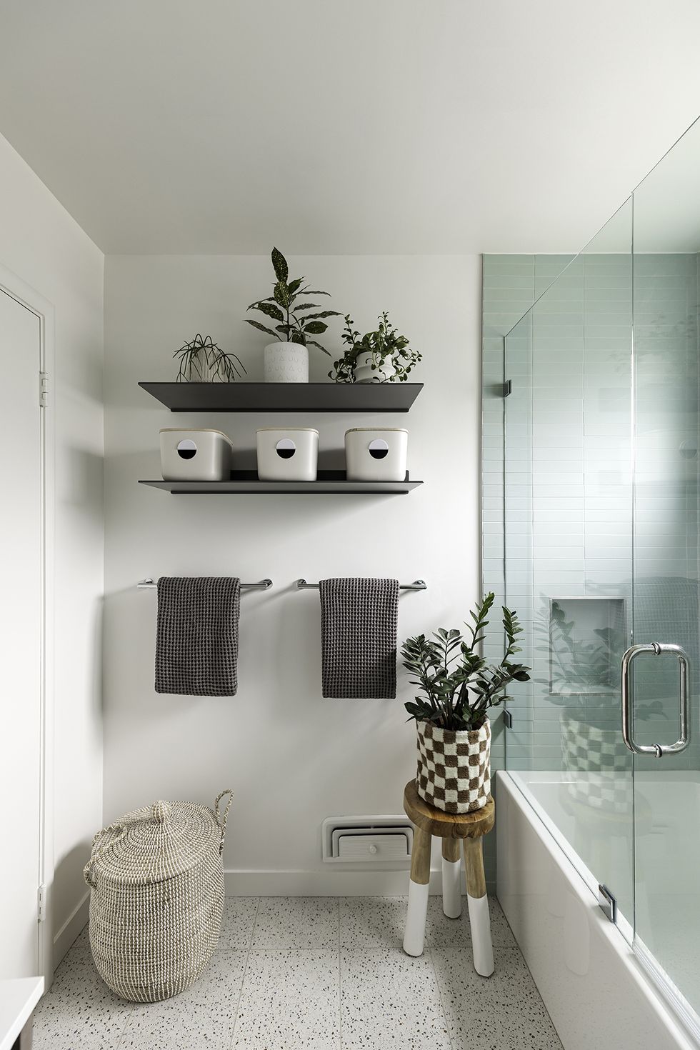 a bathroom with a shelf and a basket with plants on it