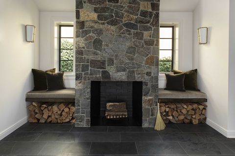 fireplace, stone fireplace, window seats, stacks of wood