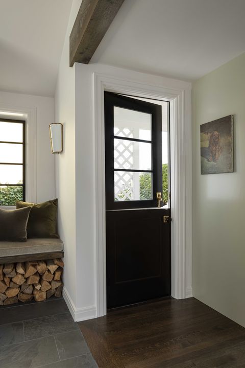 entryway, black pony door, stack of wood, window seat