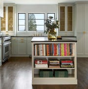 Donna DuFresne - Cumberland green cabinets kitchen, black countertops, books