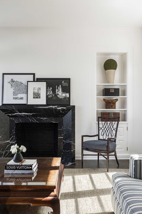 living room, black marble fireplace, coffee table, coffee table books, blue and white striped couch