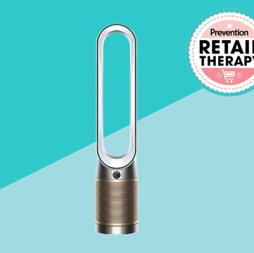 dyson air purifier in front of two blue triangles and a retail therapy prevention sticker