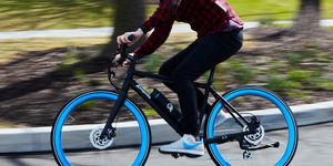 person riding an ebike with blue wheels