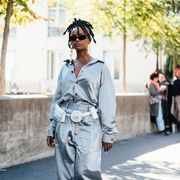paris, france   september 26 kelela wears a matching oversized silk gray striped pajama style shirt and pants, by gmbh,  white margiela tabby boots, y project multi hoop earrings, and a bond hardware white military style belt with compartments 3 pocket belt at the dries van noten show during paris fashion week springsummer 2019 on september 26, 2018 in paris, france photo by melodie jenggetty images