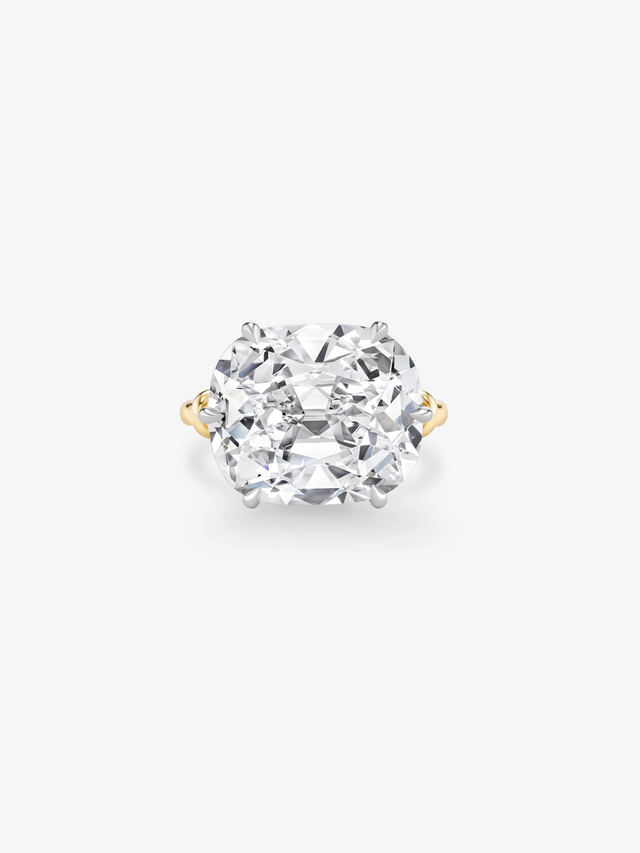 Luxurious engagement ring featuring a large, clear diamond and a two-tone band.