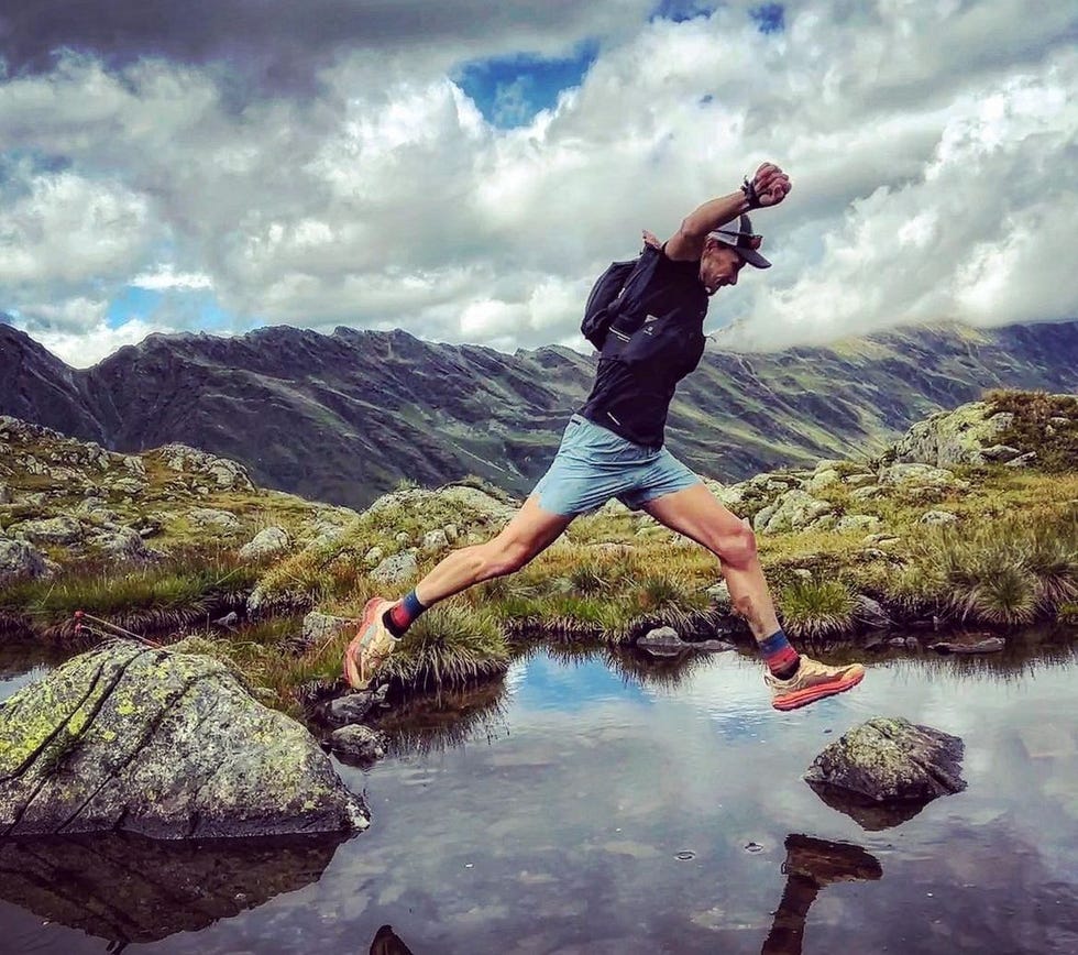 a man jumping into a lake