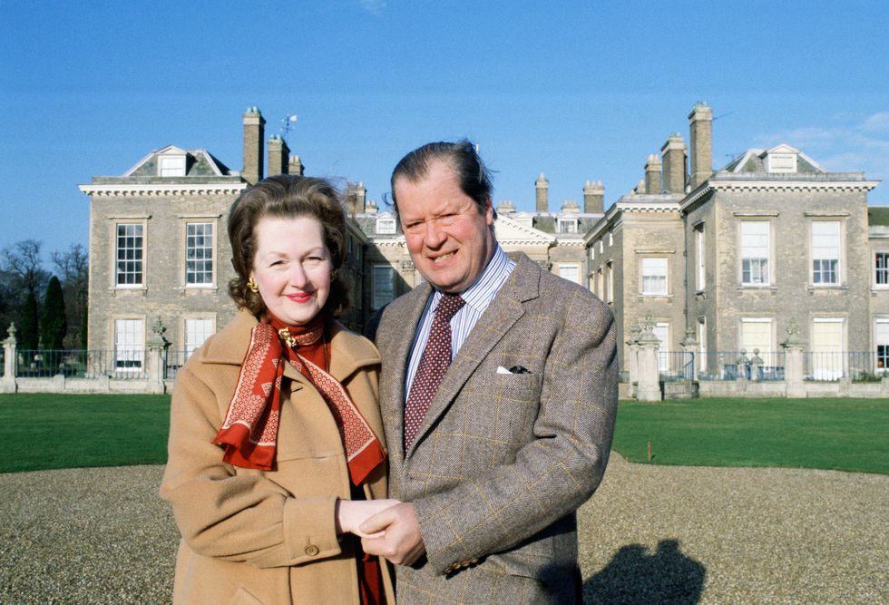 earl spencer and his wife raine in front of their home at al
