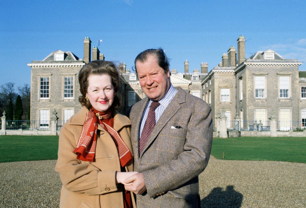 earl spencer and his wife raine in front of their home at al