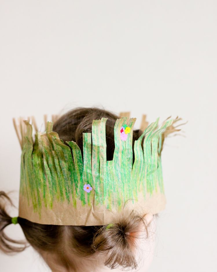 girl wearing a crown made of a paper bag