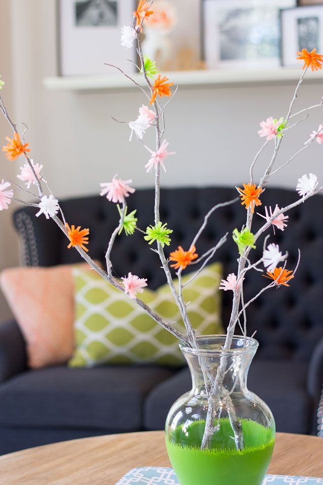 branches with colorful flowers in glass vase