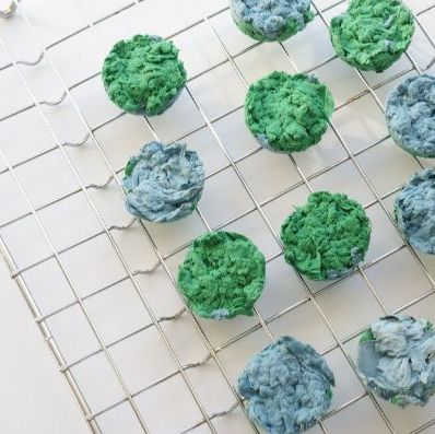 blue and green seedbombs sitting on a drying rack
