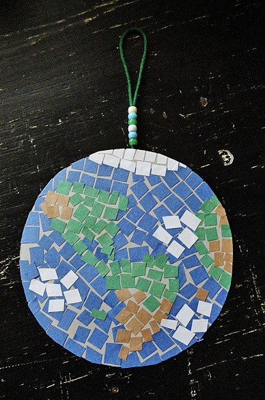 Earth day craft, mosaic earth made of green, white, blue and orange paper