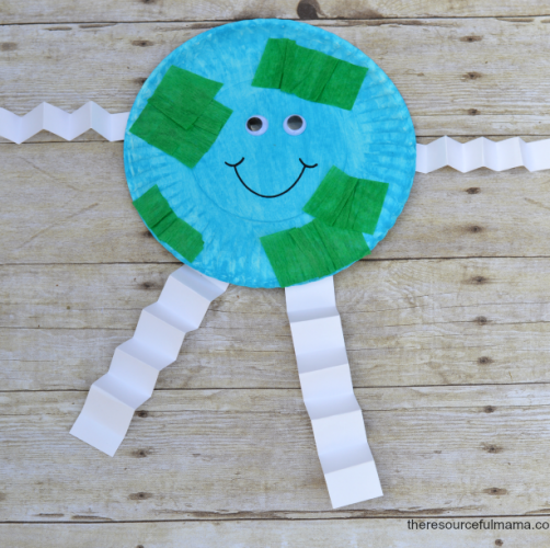 paper plate colored blue with green crepe paper, white paper for arms and legs and googly eyes