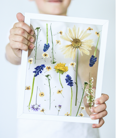 earth day crafts, boy holding pressed flowers art