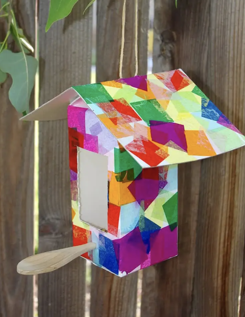 earth day crafts milk carton birdhouse on the fence