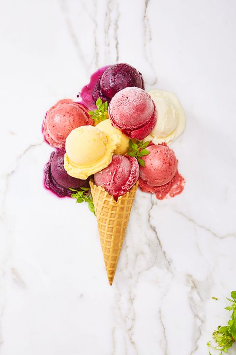 fruit and coconut ice cream with a cone on a marble background