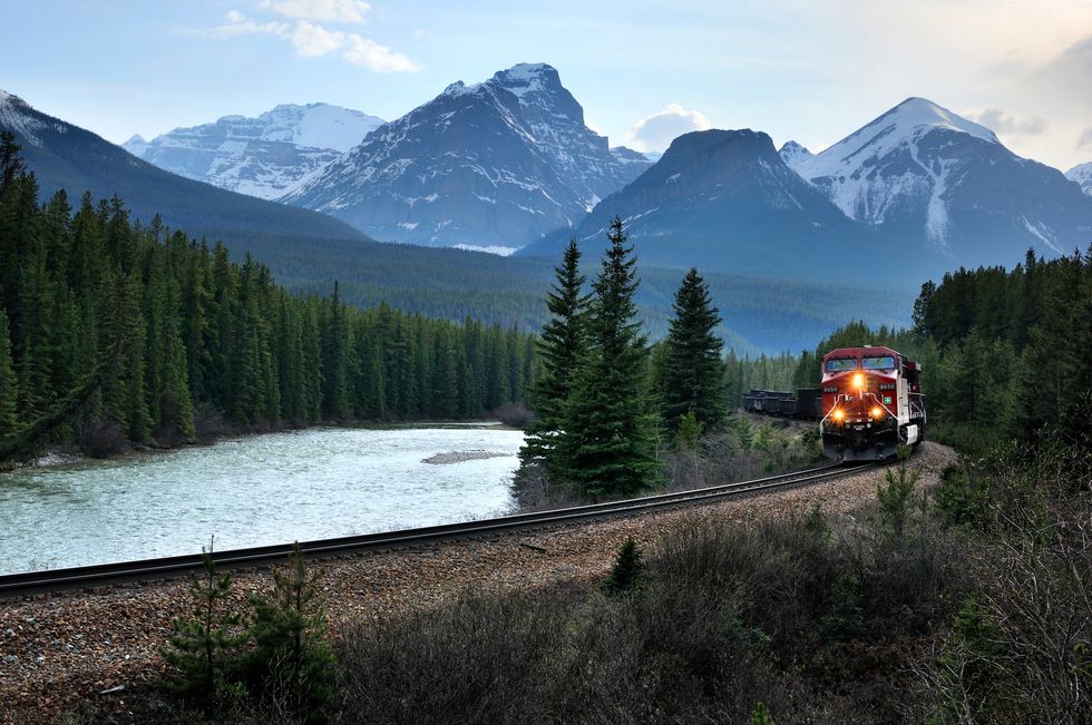 eastbound train and bow range, banff national park, alberta, canada