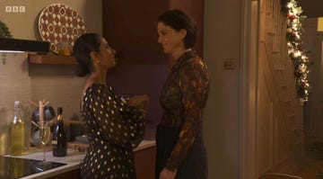 suki panesar and eve unwin in eastenders, two women talk and smile at each other in a kitchen