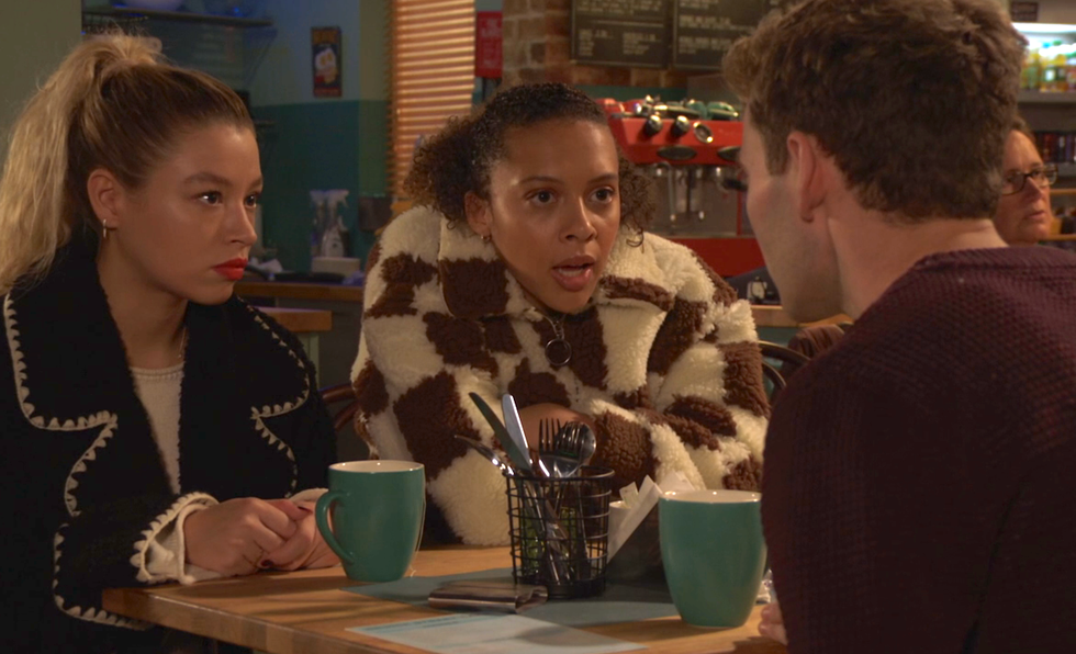 peter beale, anna and gina knight in eastenders, three people sit round a table talking in a cafe