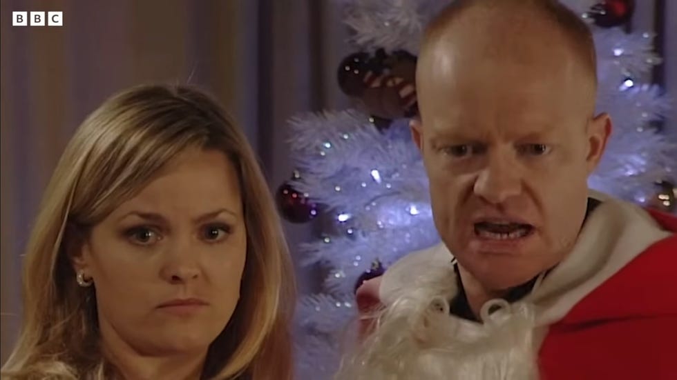 eastenders, tanya and max at christmas, in front of a tree with max dressed as santa