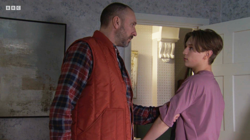 eastenders, ross grabbing joel by the arm sternly