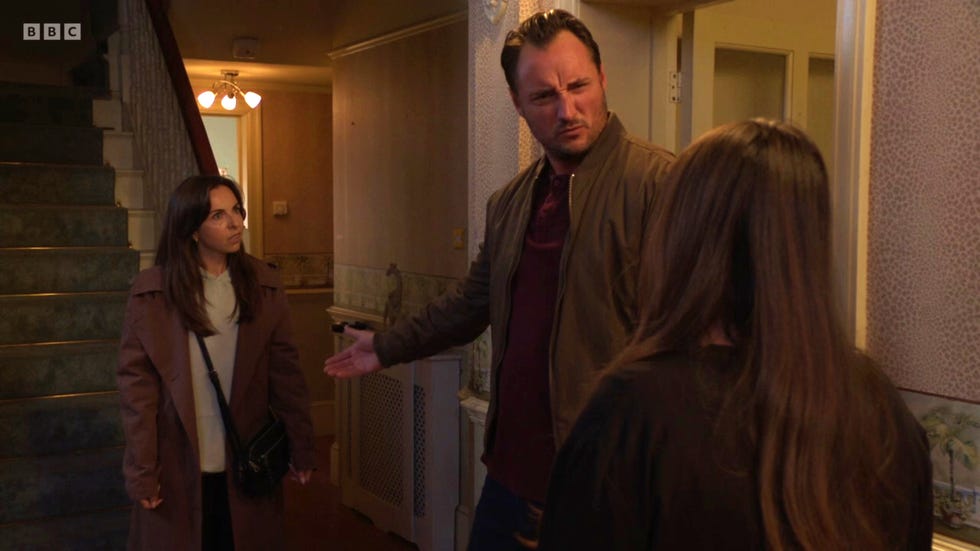 eastenders, ruby, martin, stacey, november 2024, ruby stands behind martin in the hallway as he shouts at stacey