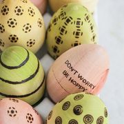 pink, yellow, and green wooden eggs and blue speckled ones