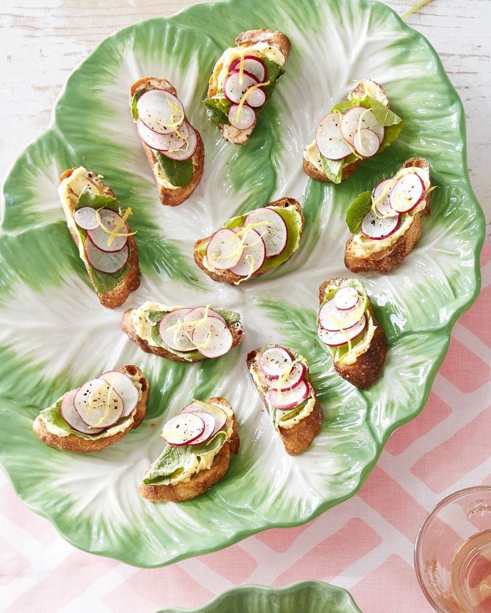 sliced radish and radish leaf toasts with lemon butter arranged on a vintage lettuce shaped plate