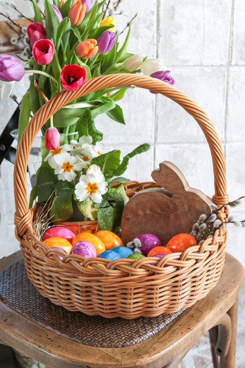 easter basket for easter egg hunt with colorful tulip flowers