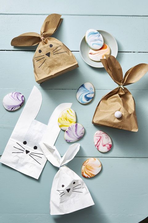 easter basket ideas, brown and white paper bags with bunny faces drawn on the front