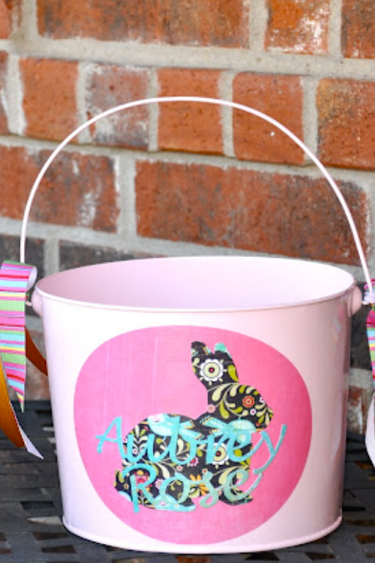 easter basket ideas chalkboard labeled easter baskets easter basket ideas, one pink and one blue bucket with bunny designs and names written on the front