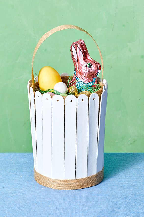 easter basket ideas, basket with white craft sticks around the exterior, holding treats inside