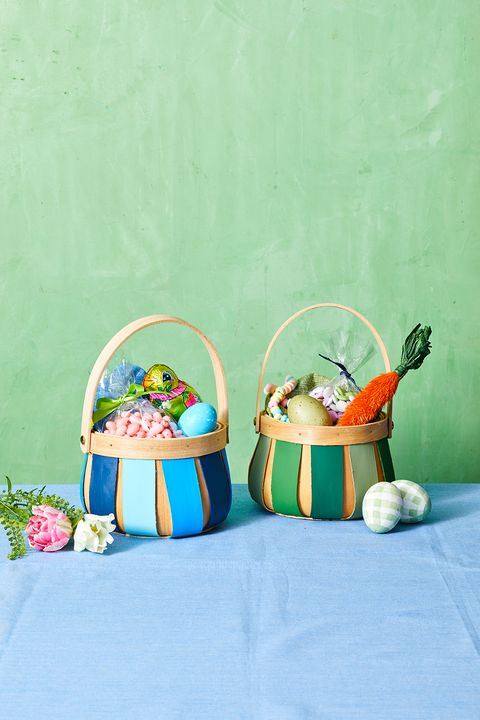 easter basket ideas, two wooden baskets painted in pastel colors and holding treats