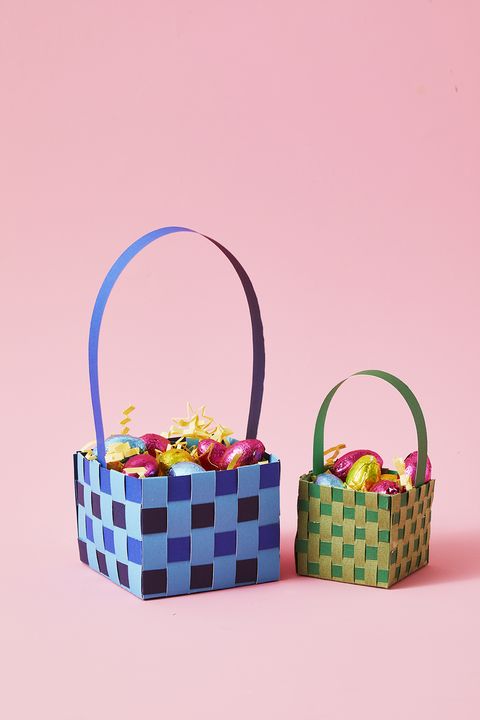 easter basket ideas, one large blue and black squared woven paper basket and one small green paper basket beside it