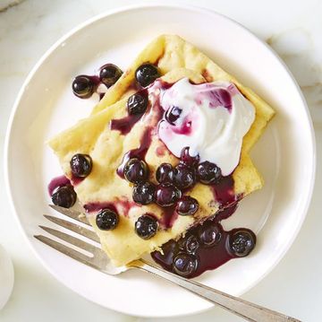 sheet pan pancake with blueberries and cream on top