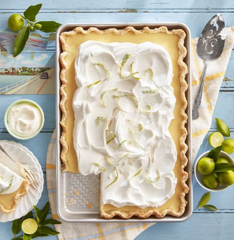 key lime slab pie with candied lime zest in a sheet pan with whipped cream on top